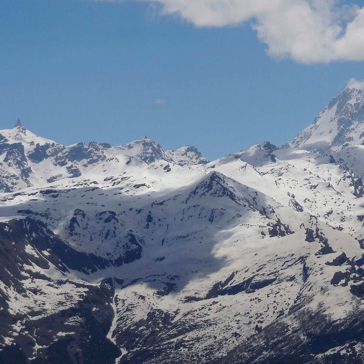 Snow capped mountains with a clear sky.
