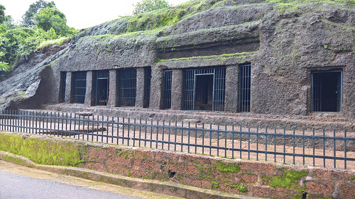 Cave dwellings at Pandava Caves covered with fence