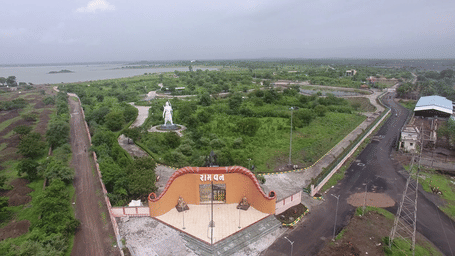 An aerial view of a small rural town with a temple.