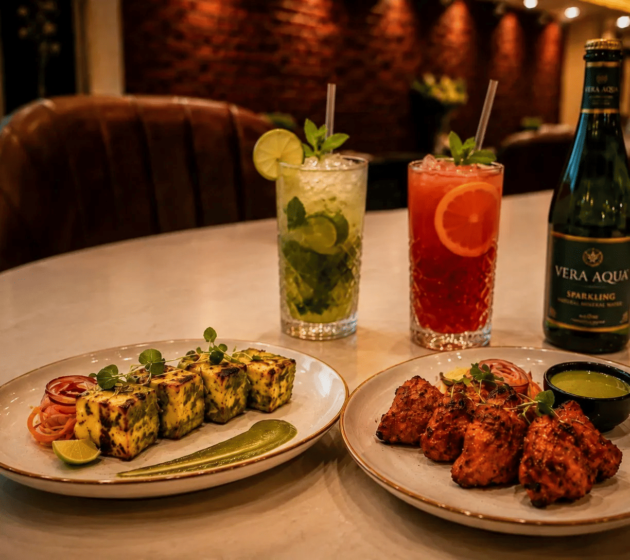 Table at Lime Tree Hotel & Banquet, Jaipur, with paneer tikka, chicken tikka and 2 mocktail drinks.