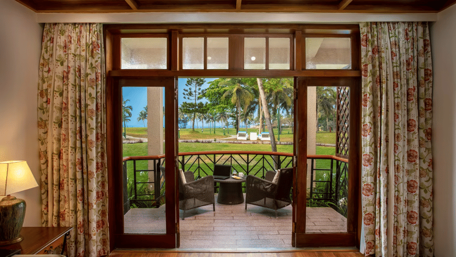 the view of the balcony with chairs on it inside the Family Villa - Caravela Beach Resort Goa