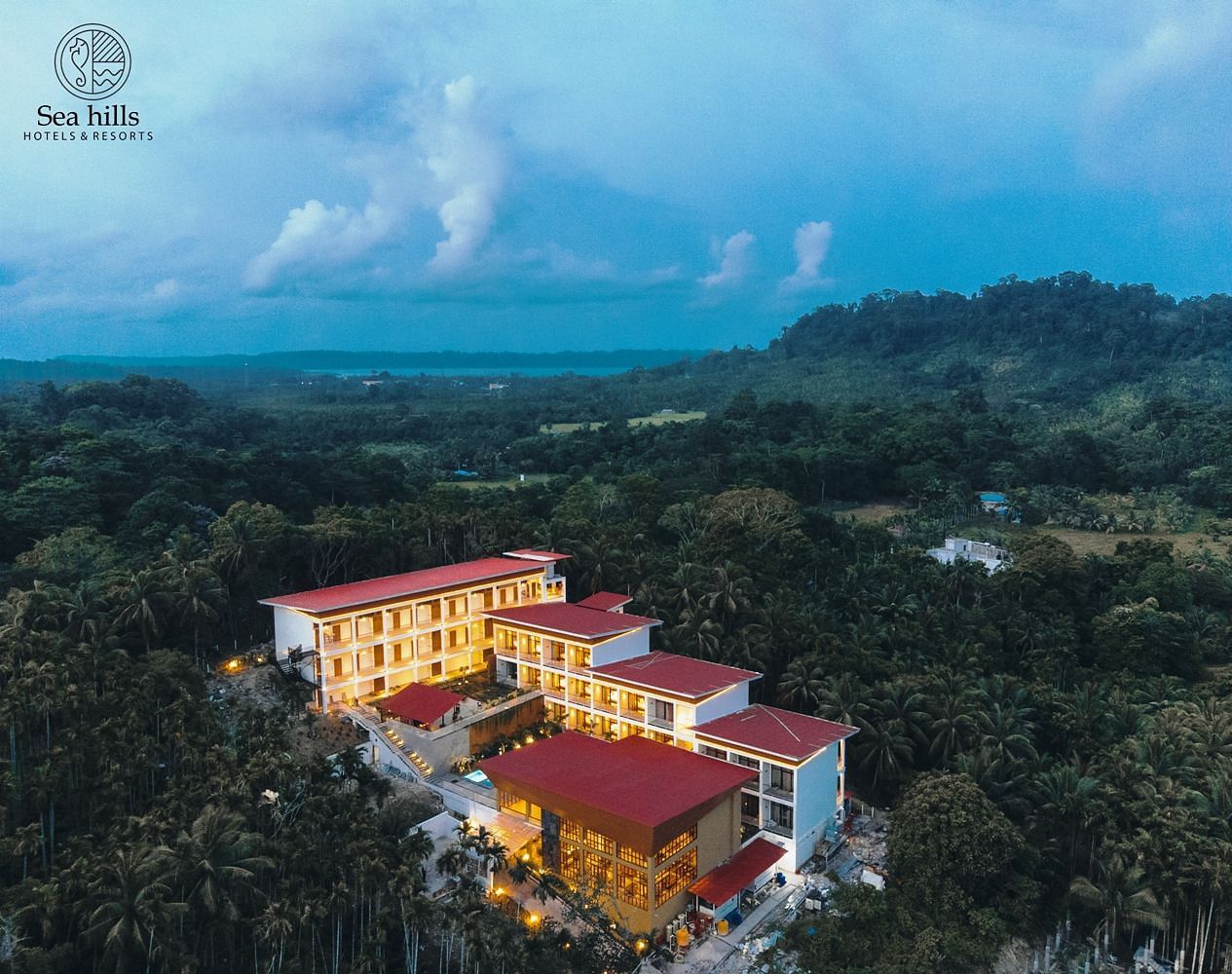 Panoramic aerial view of the Sea Hills Hotels & Resorts, showcasing the property surrounded by lush greenery and tropical landscape - Sea Hills Resort, Swaraj Dweep (Havelock)