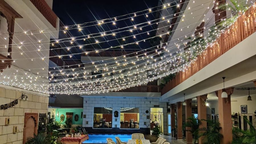 Seating arrangement with fairy lights on the top at Al-fresco Dinner at the courtyard at Suryaa Villa Jaipur