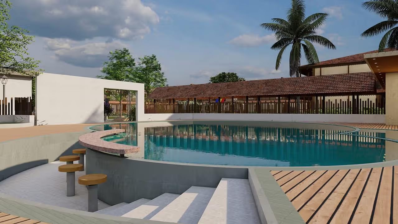 A resort with a pool area, including steps leading into the water and surrounding buildings, under a partly cloudy sky.| Ayana Resorts & Convention, Hyderabad