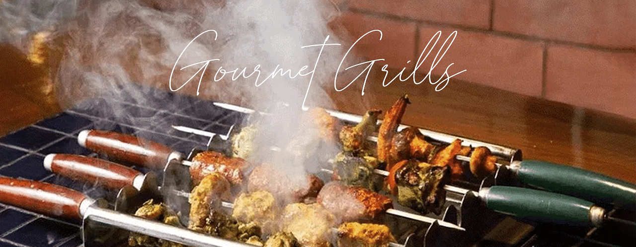 An image of a barbecue grill with chicken stuck on a skewer at Themis Barbecue House