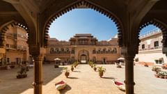 An old fort featuring its intricate architecture and courtyard under a blue sky