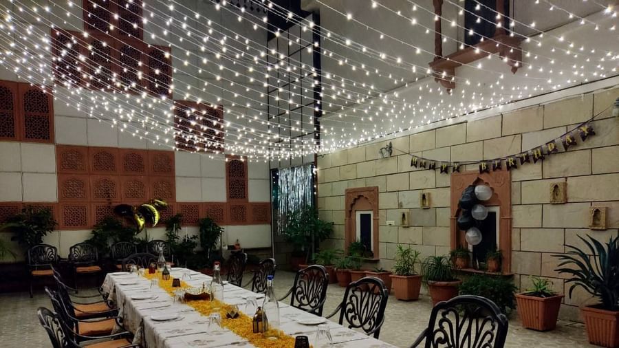 Seating arrangement with fairy lights on the top at Al-fresco Dinner at the courtyard at Suryaa Villa Jaipur