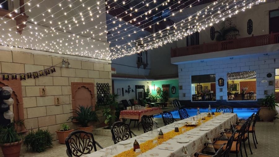Seating arrangement with fairy lights on the top at Alfresco Dinner at the courtyard at Suryaa Villa Jaipur