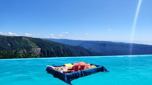 the view of a board with food on it at our infinity pool in Cherrapunjee