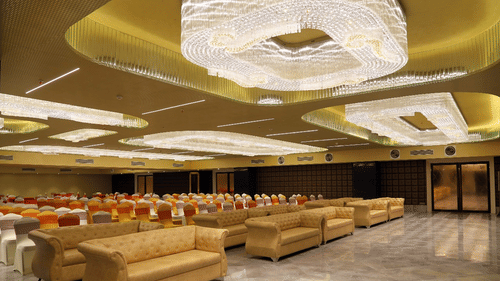 Theatre style seating arrangements inside the banquet hall with modern lights on the ceiling - VITS Bharat Nanded