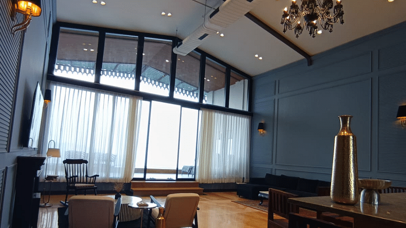 Suite with large windows, plush furnishings, and a writing desk - Polo Cherrapunjee Resort