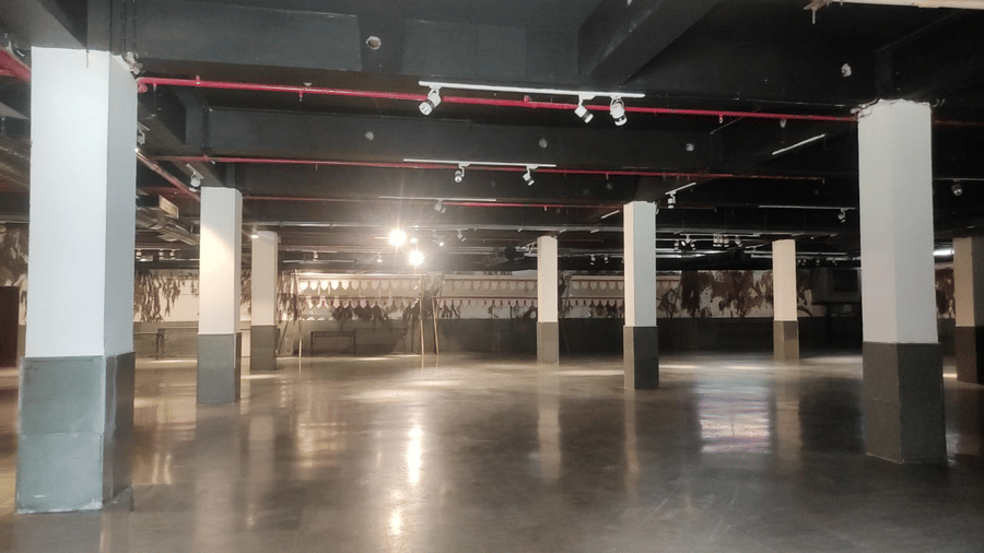 An expansive indoor event venue with open floor space, high ceilings, and structural columns, designed to accommodate large-scale weddings, exhibitions, and celebrations | Clarks Amer, Jaipur