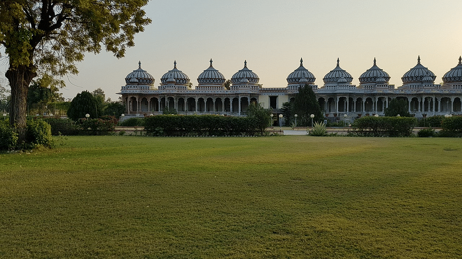 a temple in Bhilwara featuring a lawn during dayitime