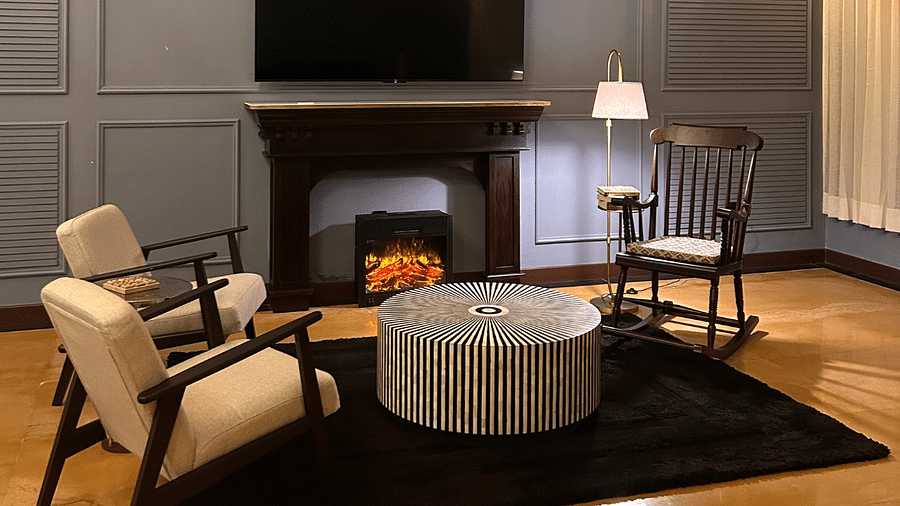 Lounge area with fireplace, armchairs, and coffee table - Polo Cherrapunjee Resort