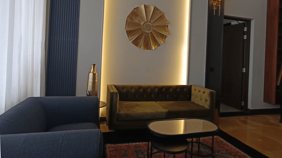 Seating area with a couch, round table, and wall-mounted decor - Polo Cherrapunjee Resort