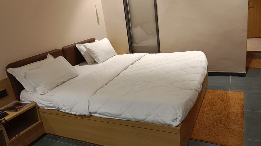 an image of super deluxe room with a king size bed and a phone line next to it at VITS Roccia Hill Resort & Adventure Park