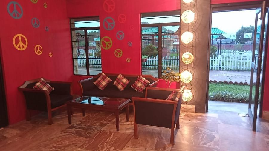 A living room with sofas and red walls