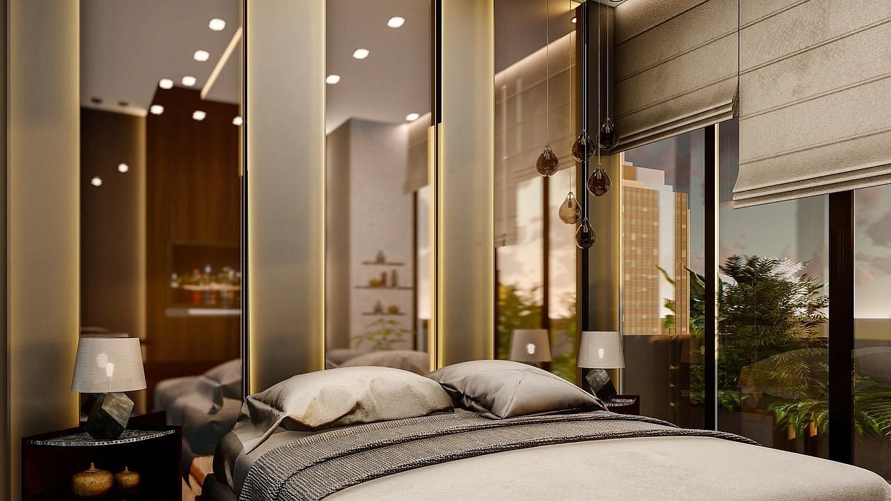 Modern bedroom with a king size bed, mirrored walls, and elegant decor.