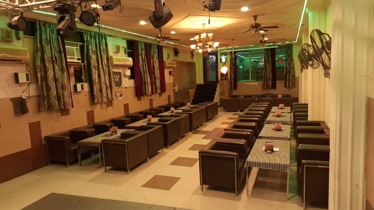 A restaurant interior with neatly arranged tables and chairs - Motel Divine International, Roorkee