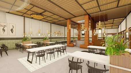 Interior view of a dining area with tables and chairs under a high ceiling - Ayana Resorts, Hyderabad.