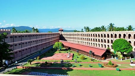 Cellular Jail in Andaman, a historic colonial-era prison with three-winged architecture, lush gardens, and a central watchtower.