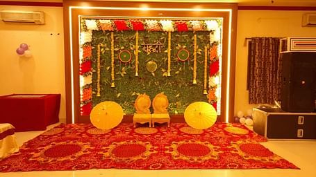 A wedding setup at our event hall in Roorkee with a vibrant floral backdrop - Motel Divine International, Roorkee