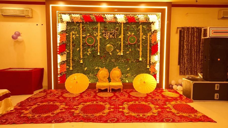 A wedding setup at our event hall in Roorkee with a vibrant floral backdrop - Motel Divine International, Roorkee