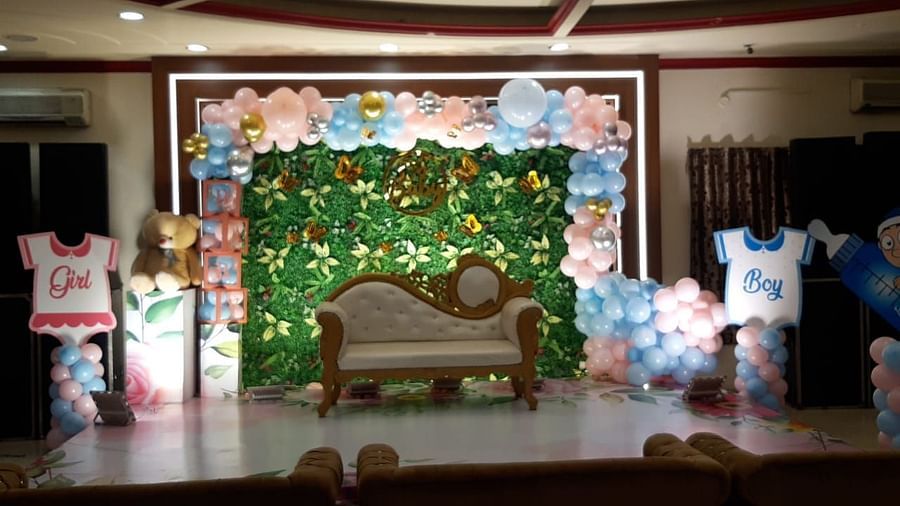 An event hall in Roorkee adorned for a celebration, featuring vibrant balloon decorations and a cosy sofa setup - Motel Divine International, Roorkee