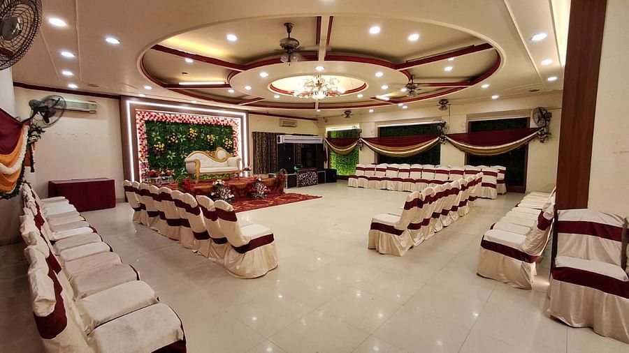 An image of a party hall near IIT Roorkee, adorned with a beautiful chandelier, elegant decor, and neatly arranged chairs - Motel Divine International, Roorkee