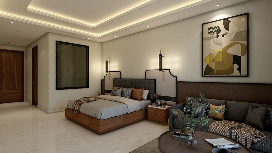 A bedroom with slightly low lighting featuring a double bed with an artistic head board along with a common seating area besides it. - Namaste Corbett