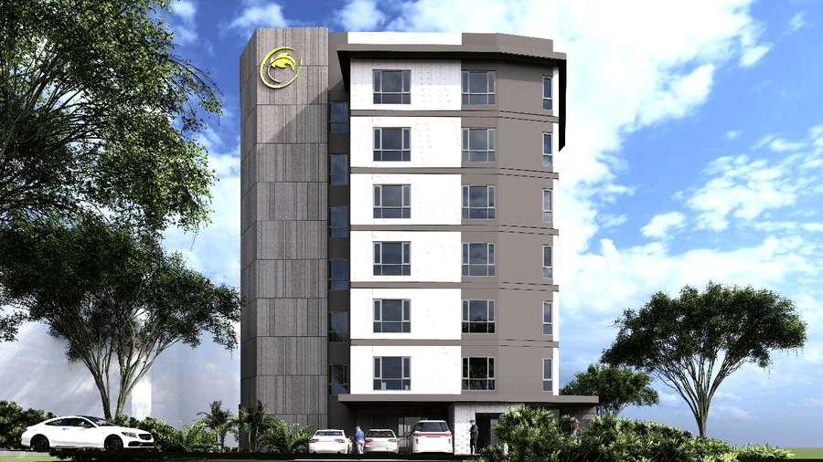 A daytime exterior shot of the high-rise Citi Residenci Hotel, Palashdiha, displaying its prominent hotel logo on the upper corner of the building facade against a vibrant sky bordered by green trees.
