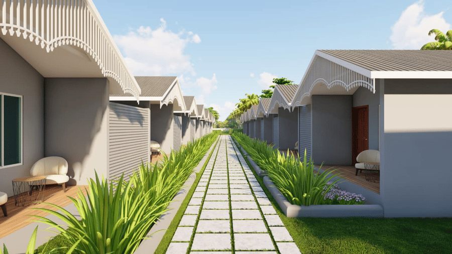 A walkway lined with plants separates two rows of houses with curved roofs at Trishvam Palolem Beach Resort, Goa.