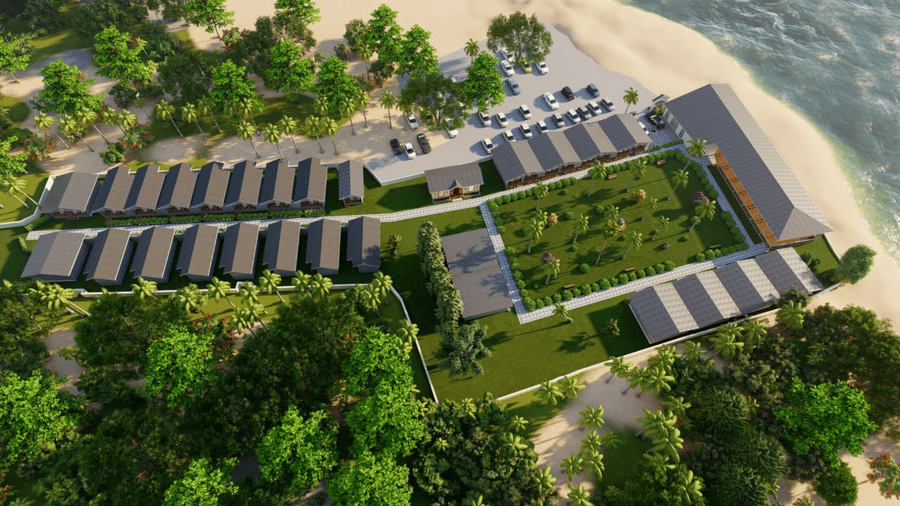 An aerial view of Trishvam Palolem Beach Resort, Goa, with units of houses nestled between the greenery by the shore.