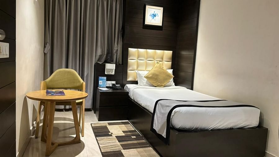 a view of a single bed and a work desk  of Colony Single bed room at Wonder country club resort