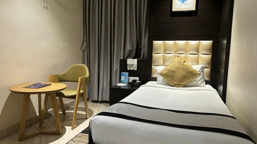 a view of a single bed and a work desk of Colony Single bed room at Wonder country club resort