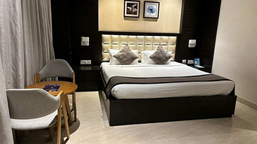 a view of king bed and a work desk of Premium Colony King bed room at Wonder country club resort