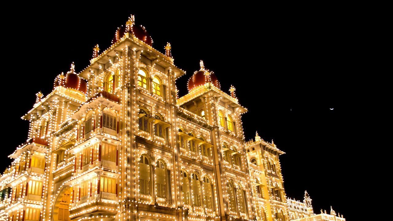 Illuminated palace glowing against the night sky with intricate architecture.