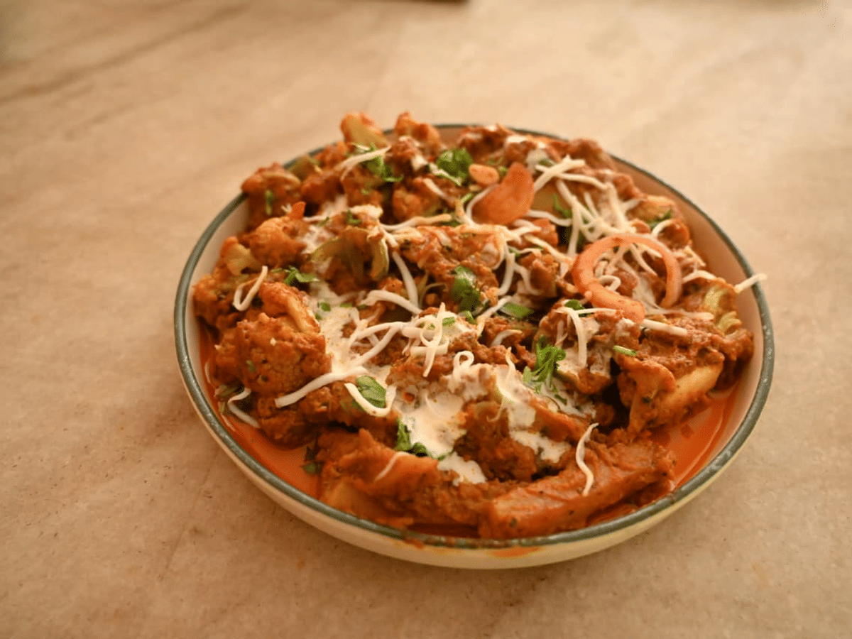 Slow-cooked curry served in a traditional bowl at Signum Resort, Bandhavgarh