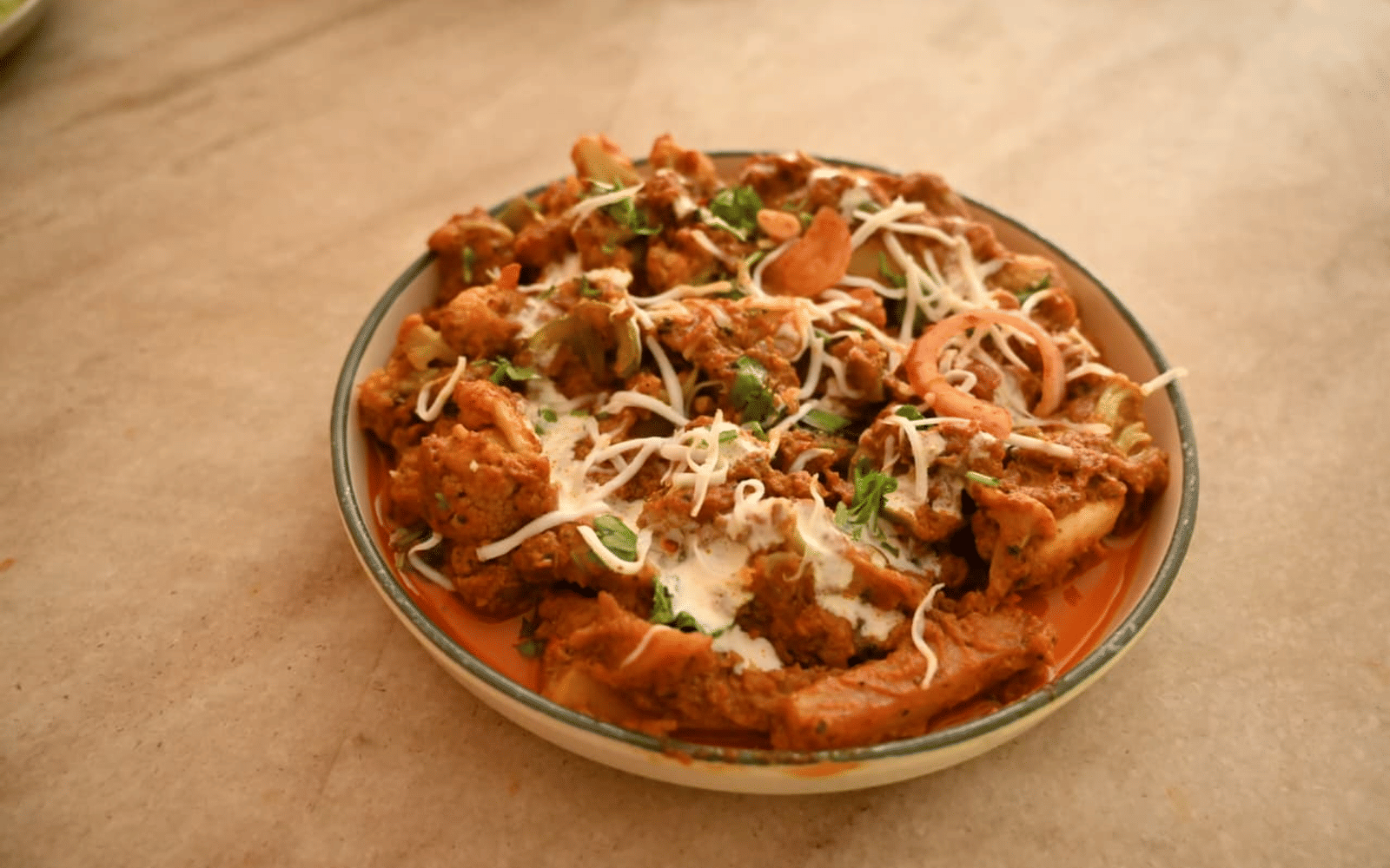 Slow-cooked curry served in a traditional bowl at Signum Resort, Bandhavgarh