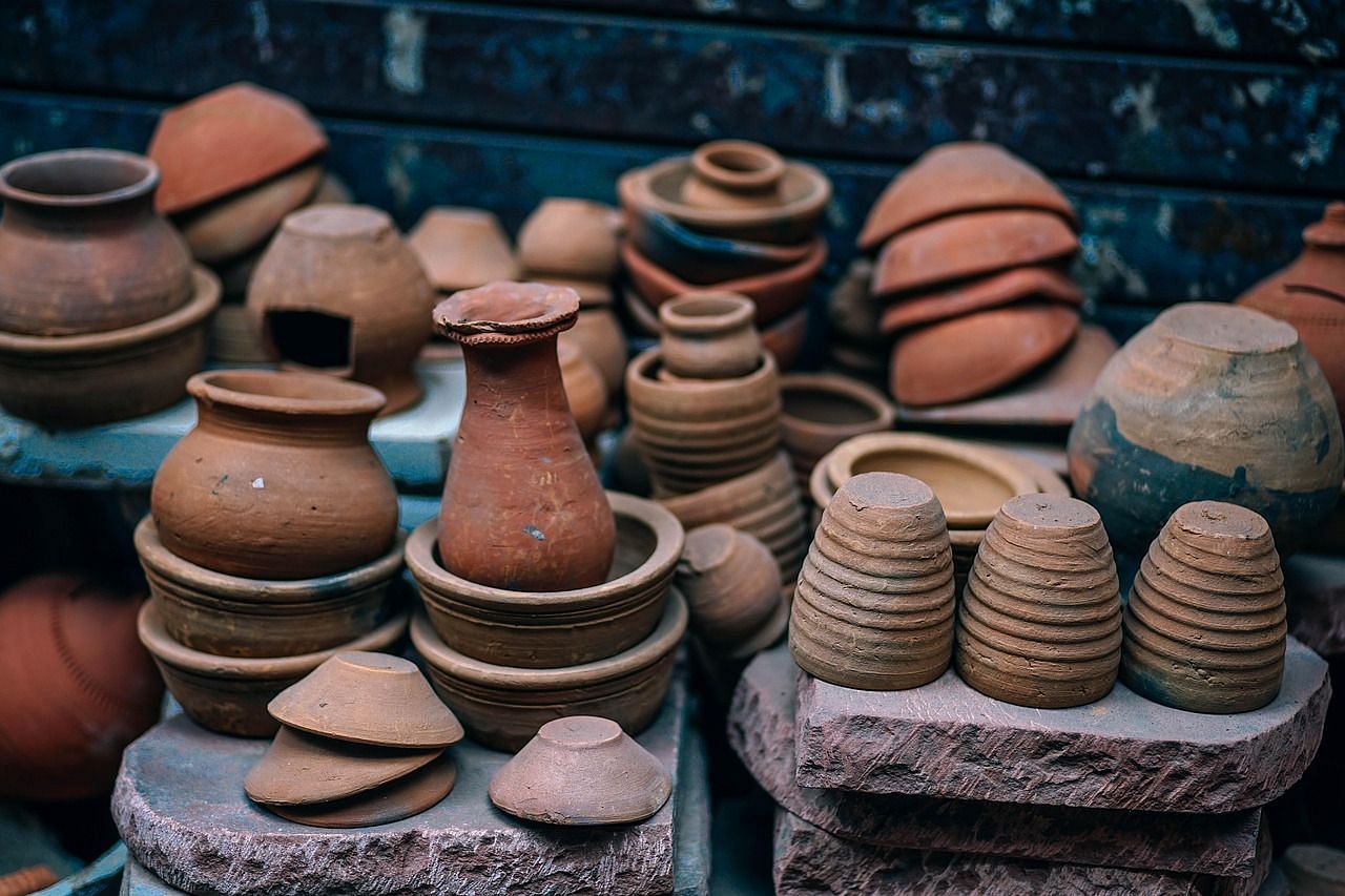 various earthen vessels stacked on top of one another on a roadside shop