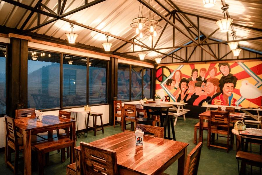 A warmly lit dining space in Woodstock resort, with view of the outdoors 