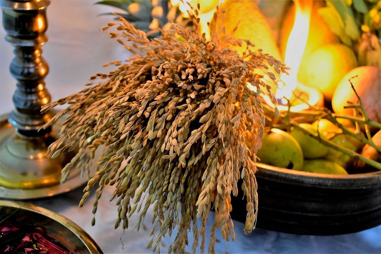 image of a basket with a lots of fruits and an earthen lamp brightly lit that is made for Vishu festival in Kerala.