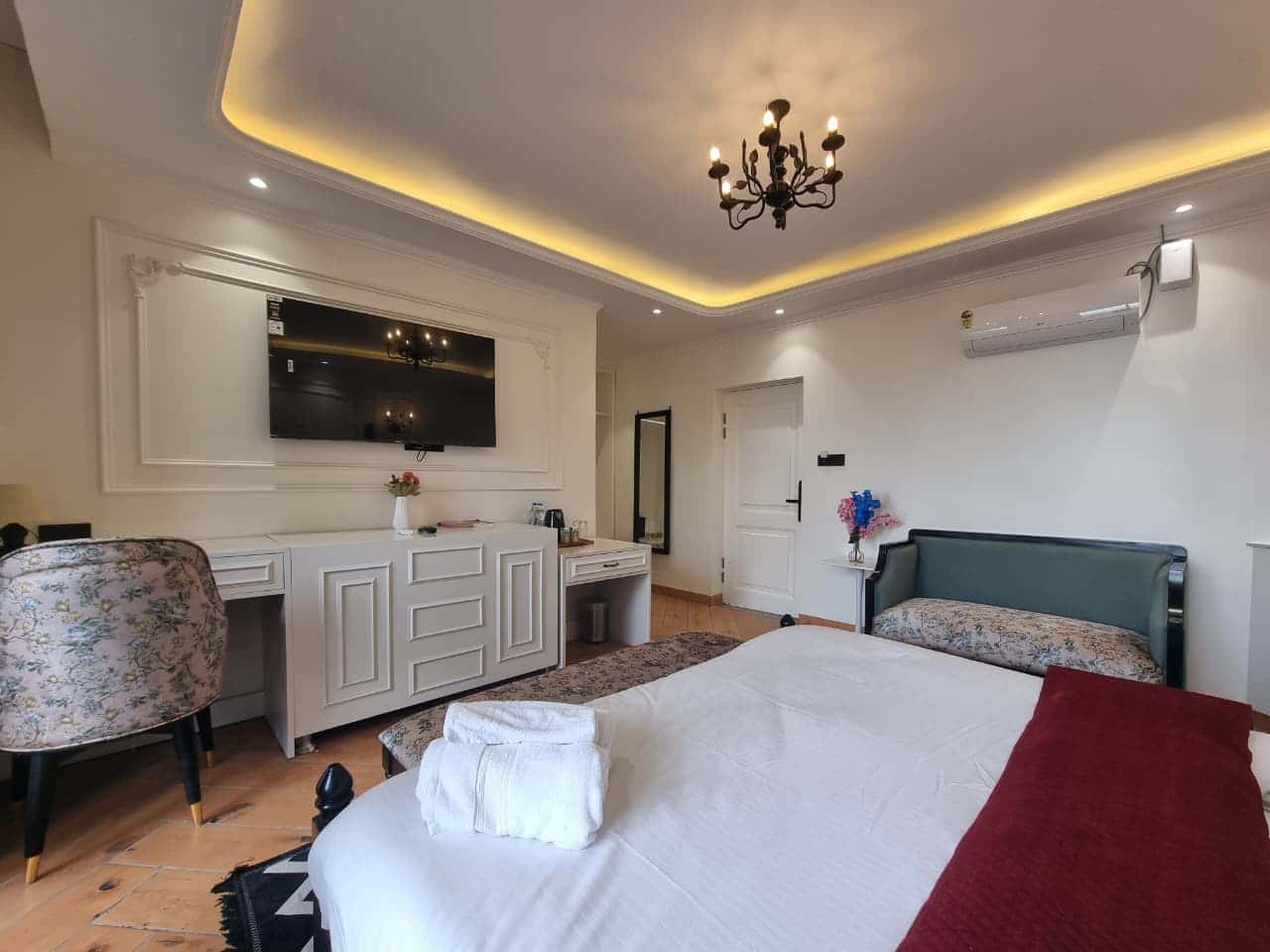 Air-conditioned king room with elegant sofa seating at Akasa Dalhousie