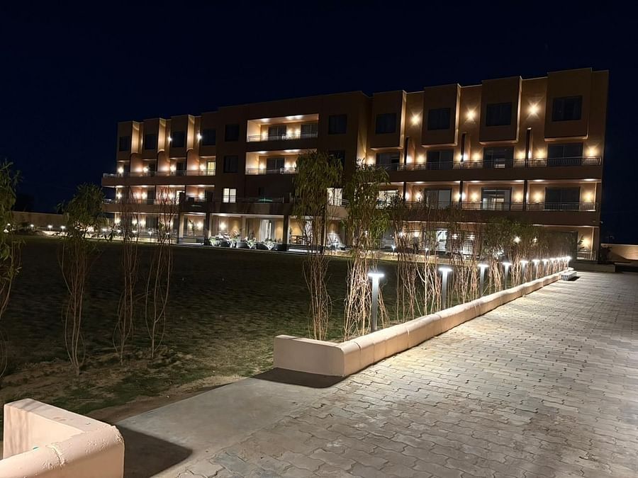 An image of a facade at night from where lights are turned on every floor of the building - Pride Hotels Group