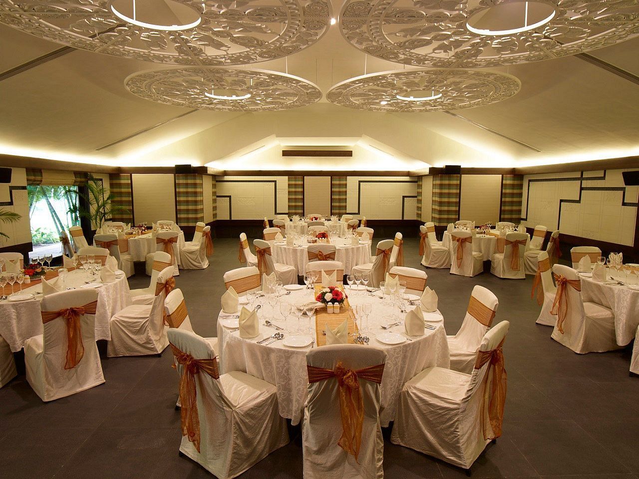 View of a banquet hall with round tables and chairs.