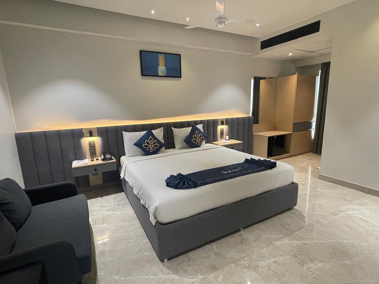 Suite with a neatly arranged king size bed and side tables at Hotel Kyzen HiTech City – Your Zenly Stay