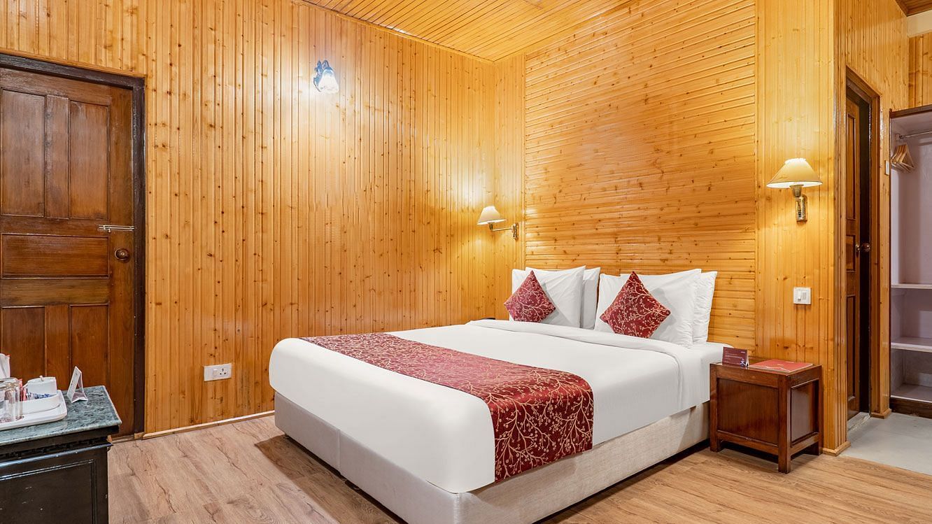 Image of  a room with bed and lamps mounted above the bed at Summit Tashi Ghang Heritage Resort, Pelling