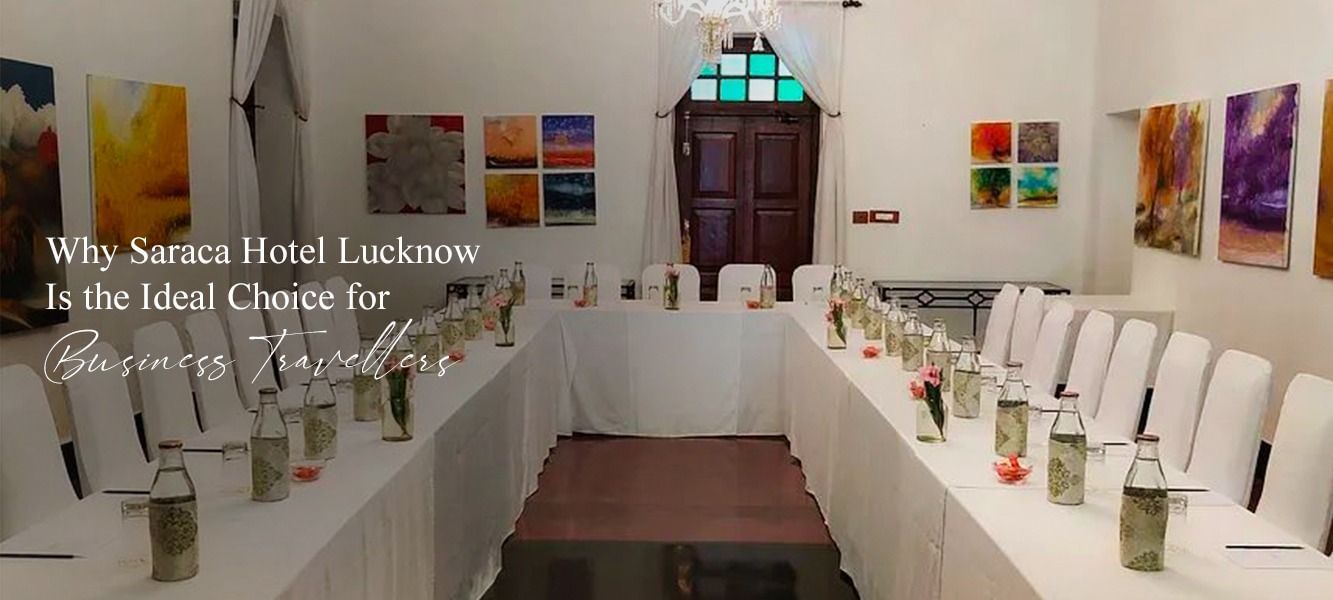 Elegant banquet hall setup with white chairs and tables under warm lighting.