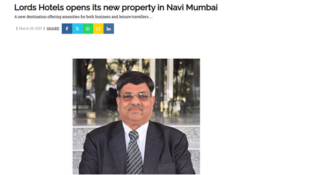 A close-up professional photo of a man in a suit and glasses, likely a Lords Hotels executive, featured in an article about a new property launch.