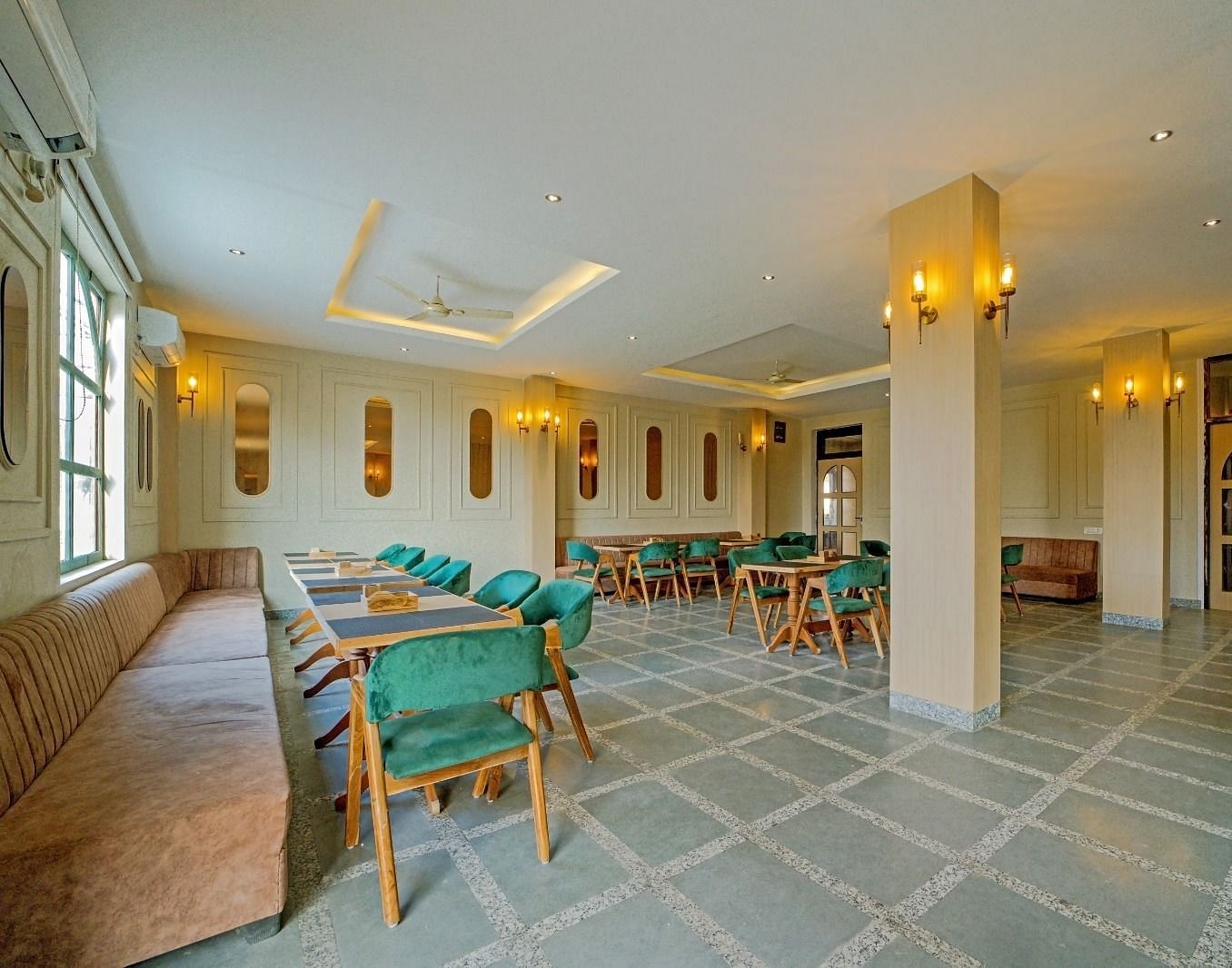 Dining area at Grassfield Riveria Resort, Jaipur, featuring stylish seating, soft lighting, and a spacious, elegant atmosphere.